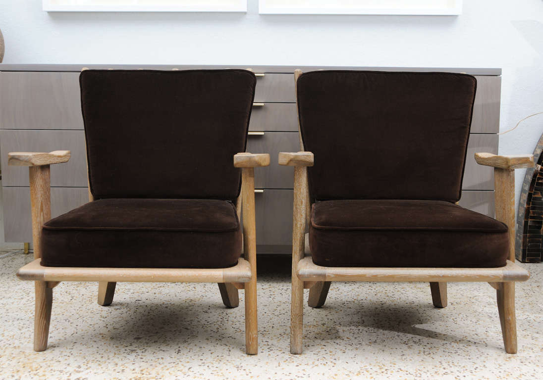 We love so many things about this pair of armchairs by Guillerme Et Chambron - The cerused tobacco oak frame, the quirky, casual, beach-chic design, and its relatively smaller scale. Upholstered 