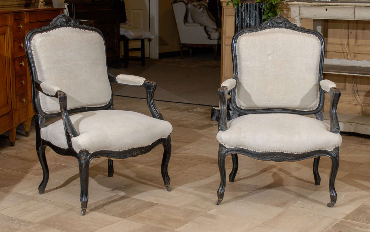 Pair of 19th Century Black Painted Louis XV style Arm Chairs, Circa 1880
We love the black painted frames of this pair of chairs.  The carving is excellent.  The chairs are comfortable and the profile is very graceful.