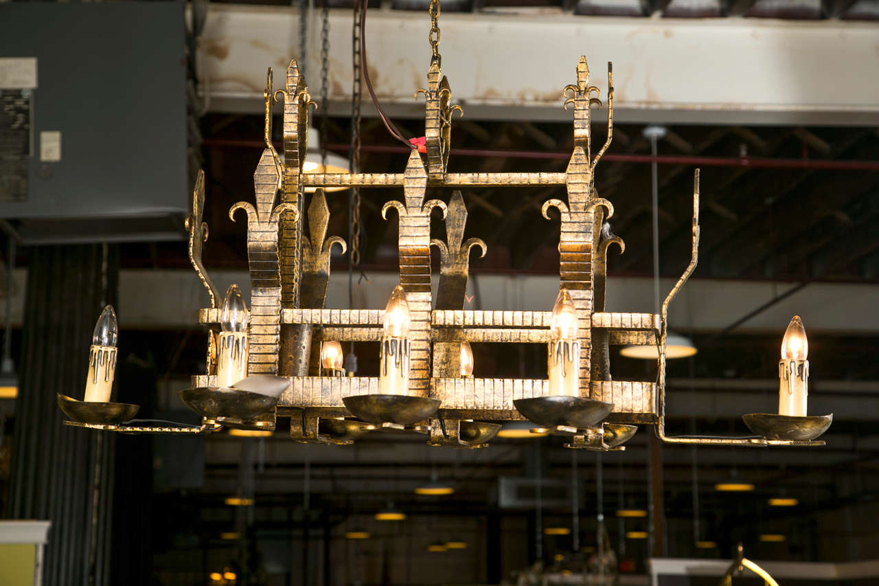 Iron chandelier in the Gothic Revival style, eight arms with dripping candlesticks sleeves and two down lights, late 19th century.