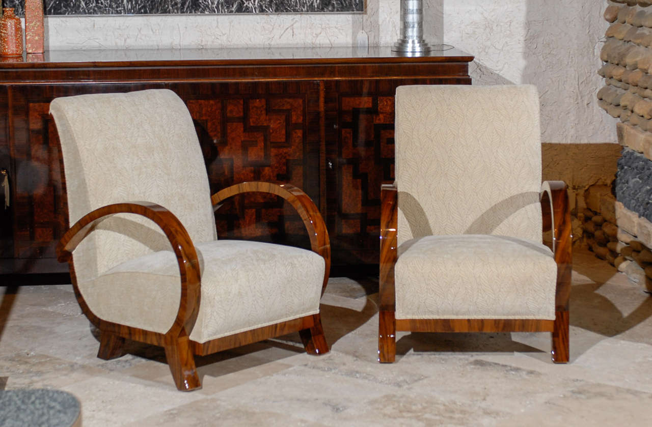 Pair of curved arm art deco chairs, walnut veneer with ivory leaf fabric