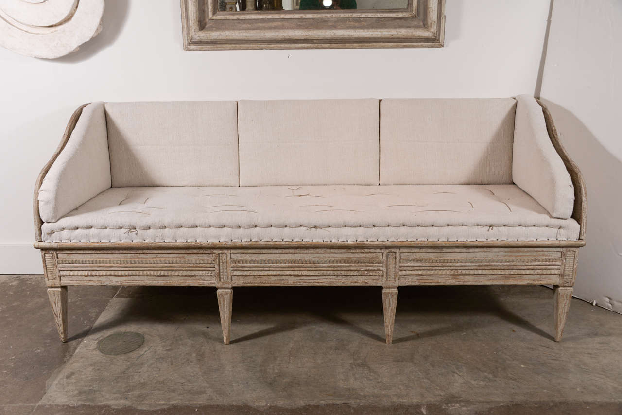 Early 19th century Swedish painted bench with upholstered cushions.