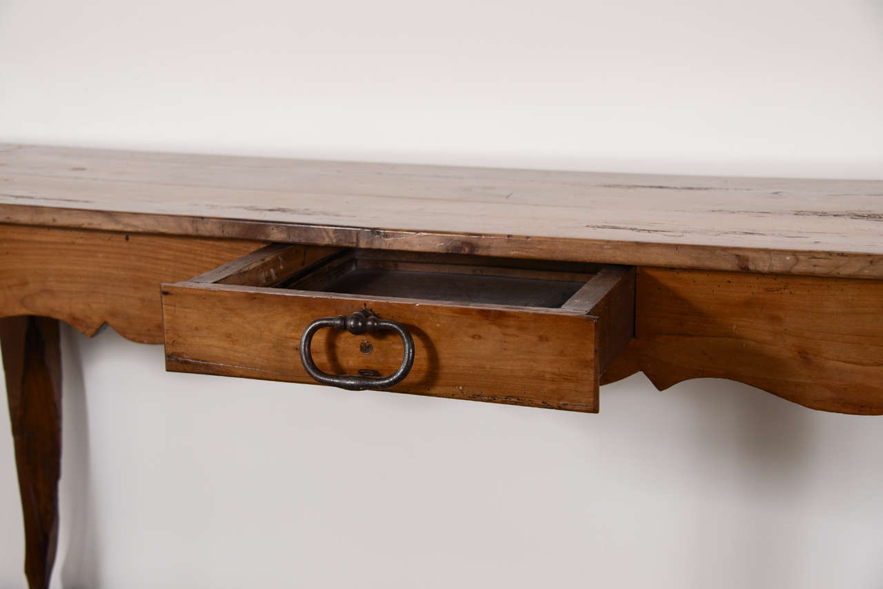 19th century narrow French cherry console or server with carved frieze all the way around. One drawer, circa 1870.