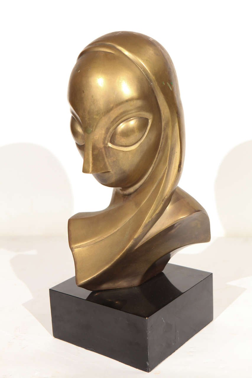 A wonderful vintage midcentury brass female bust mounted on a black Lucite base. There is a light dent (hardly noticeable) on the back of the head. Very presentable and impressive.