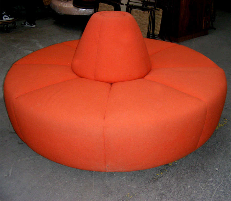 1970s circular ottoman in the style of Pierre Paulin, in foam and orange fabric.