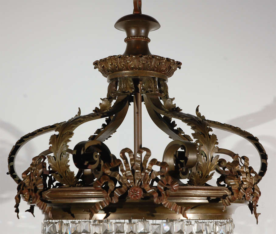 Beautifully wrought bronze and crystal chandelier. Incredible garland and floral detail.