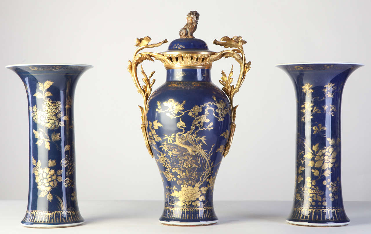 A set of three 18th century, Chinese powder-blue gilt-decorated vases 
Each painted with composite floral patterns, the jar with the lion-shaped finials cover with a 19th century, French ormolu-mounted

Measures: cm 39 jar cm 53.