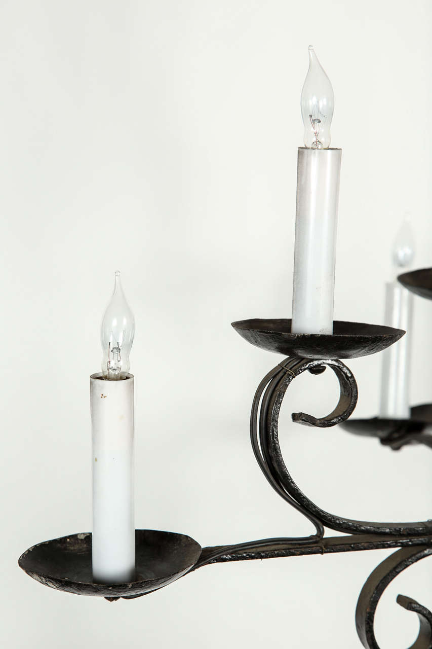 Eight-candle wrought iron chandelier. Two tiers of lights. Four per tier.