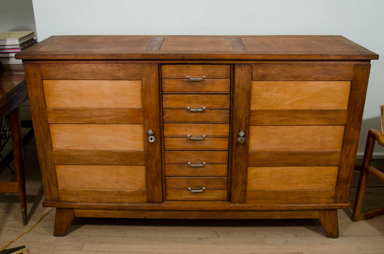 1950s sideboard in the manner of Pierre Jeanneret. Oak with nickel-plated hardware.