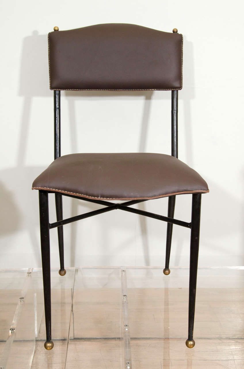 Single Jacques Adnet leather and wrought iron side chair, rests on 4 tapered legs with ball feet.