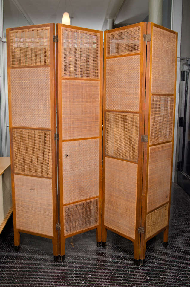 Rare Edward Wormley four-panel cane and walnut screen, mfg. Dunbar. Brass label underneath. Each panel is 19