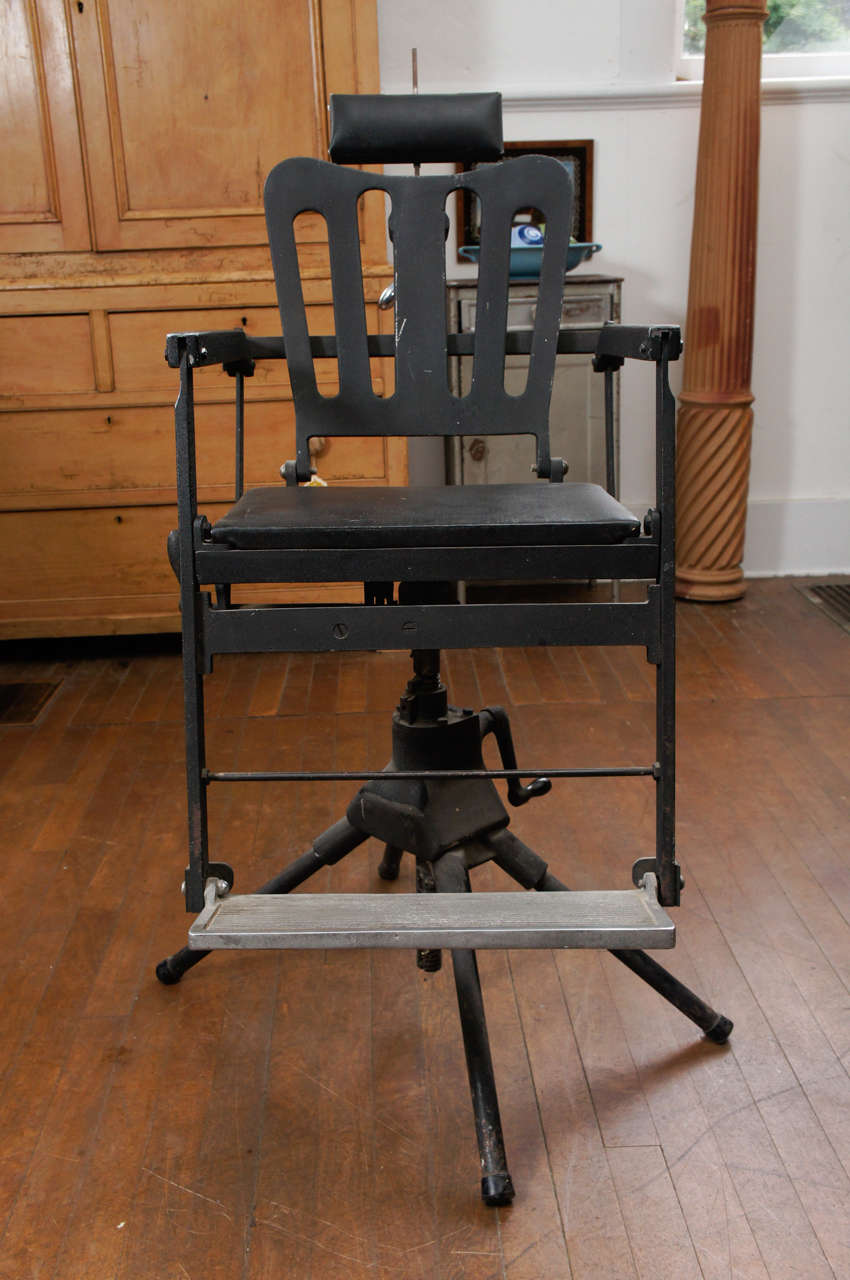 19th century cast iron dentists chair with collapsible stand
and adjustable head and foot rest.