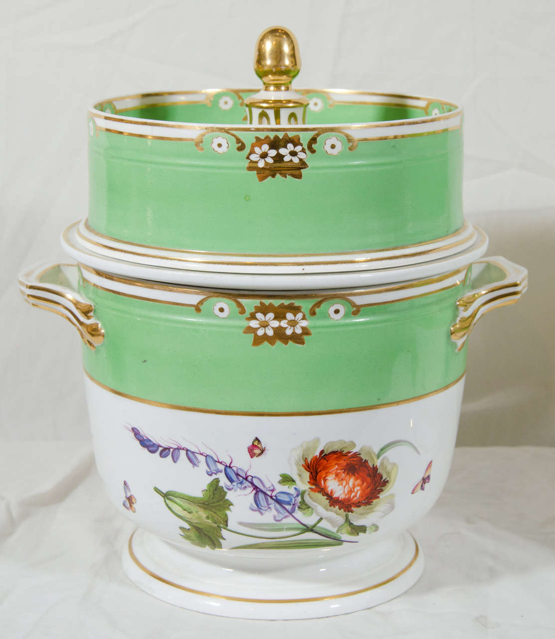 A lovely pair of Derby porcelain ice cream pails (fruit coolers) decorated with hand-painted flowers and broad bands of apple green.
Made in three pieces ice cream pails were commonly placed on the sideboard and used for serving iced cream mixed
