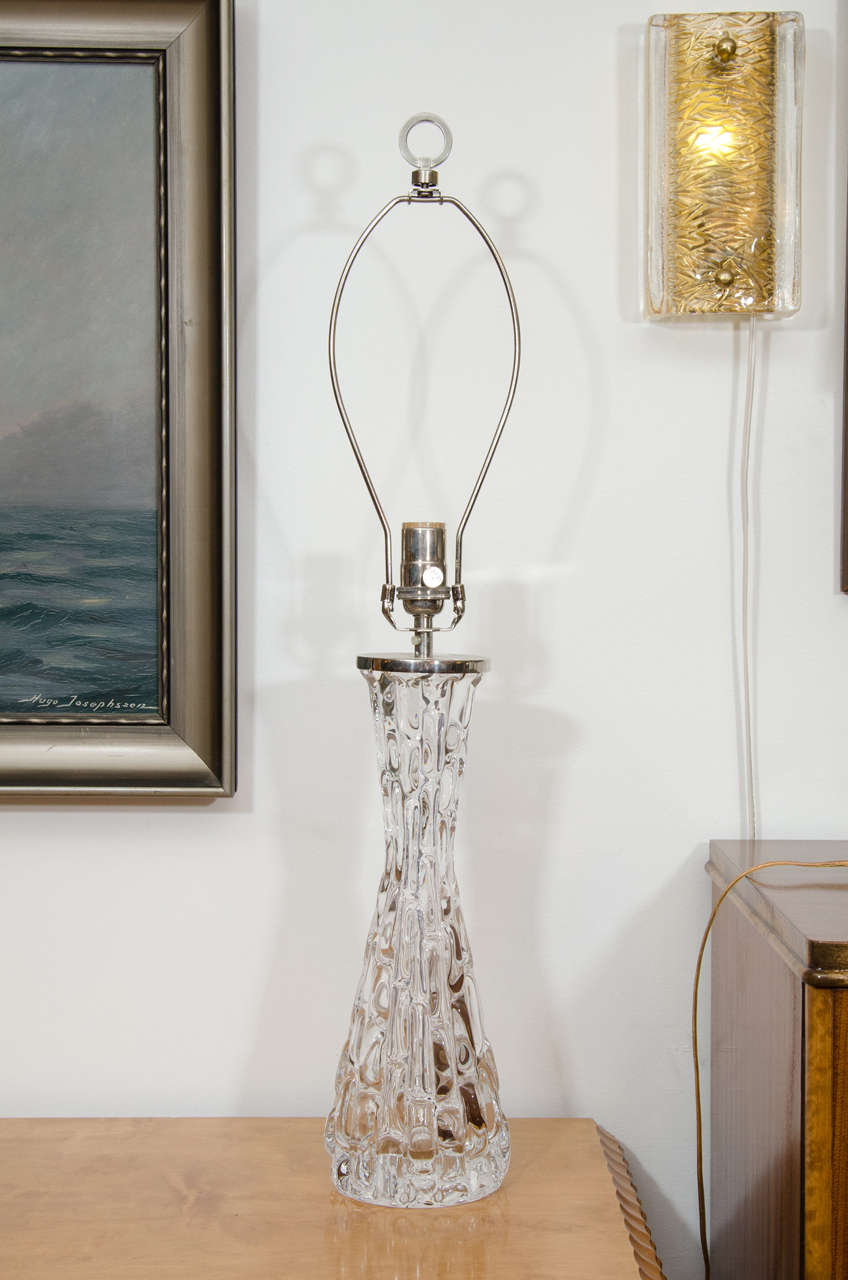 Pair of table lamps like their little sisters, posted earlier, these long, sparkling lamps with hourglass figures are designed of clear undulating, moulded glass which reflects their own wattage as well as the ambient light which passes through