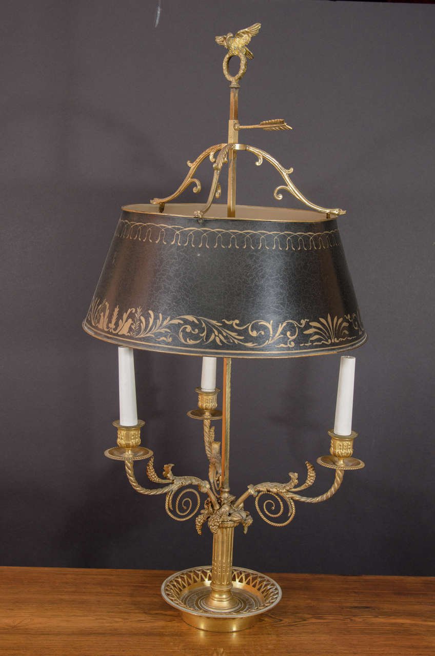 Fine Louis XVI bronze three-light bouillotte lamp, the spiral scrolled arms issuing from a chased column stem topped with clustered fruit and with a lattice pierced tray. The dark green tole shade with scroll decoration.