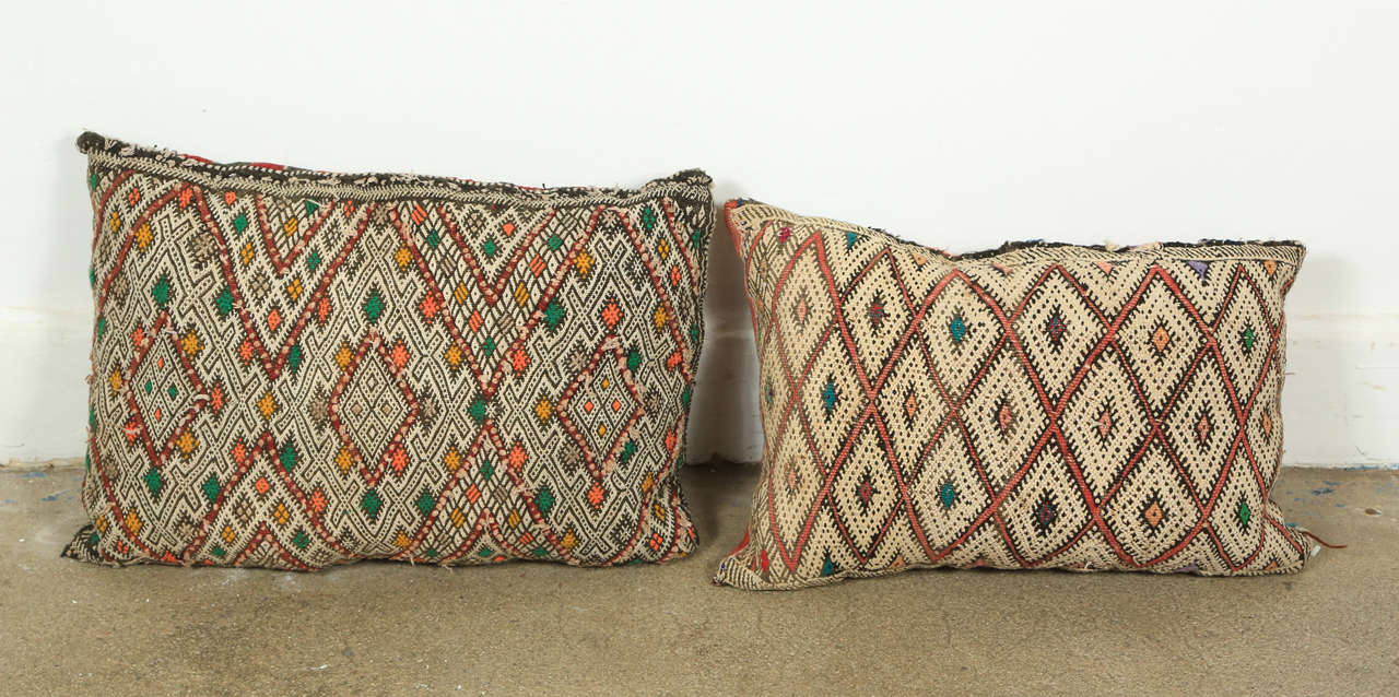 Handwoven tribal throw pillows made from vintage rugs.
The front and the back are made from a different rug, front is more elaborate and back is striped.
Measures: One pillow with red and black back is 21