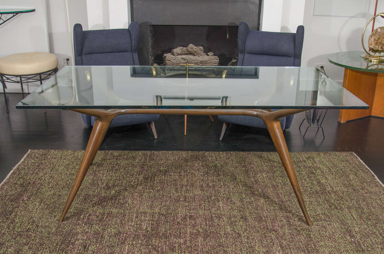 Beautifully crafted dining table by Italian designer Carlo di Carli. Walnut legs with glass top. Base: H 29” x L 60” x D 30” / Glass Top: 36”x 72”