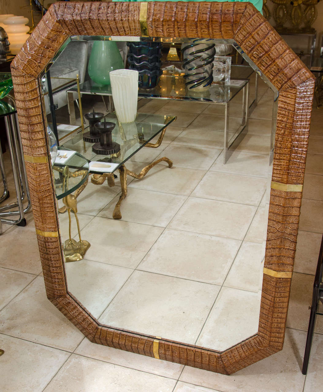 Large octagonal mirror with brass and alligator surround in the manner of Karl Springer.