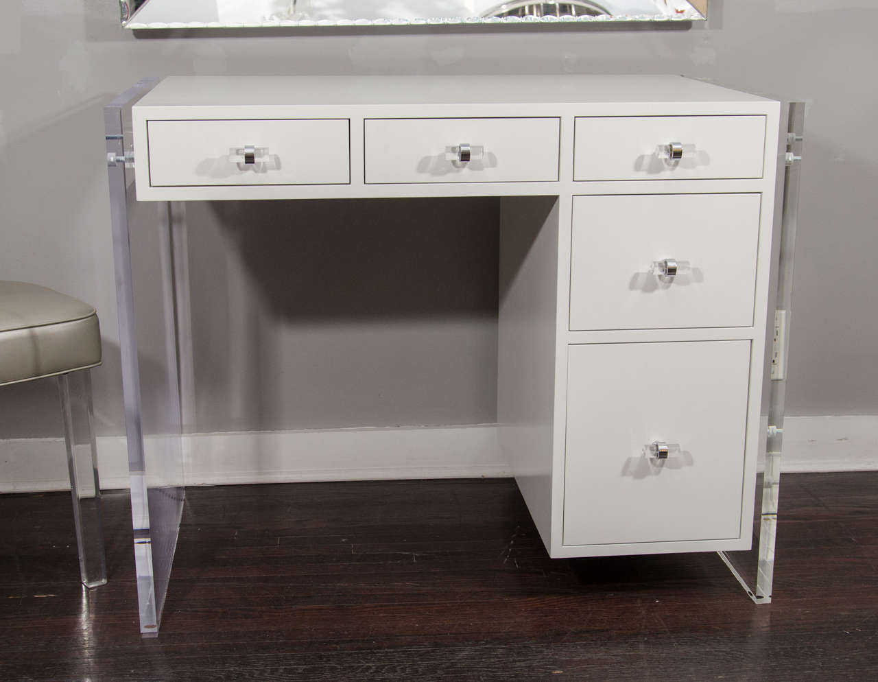 Custom white lacquer desk with Lucite side panels, with Lucite knobs in chrome finish. The interior of the drawers is spray lacquered in white. customization is available in different sizes, colors, and hardware.