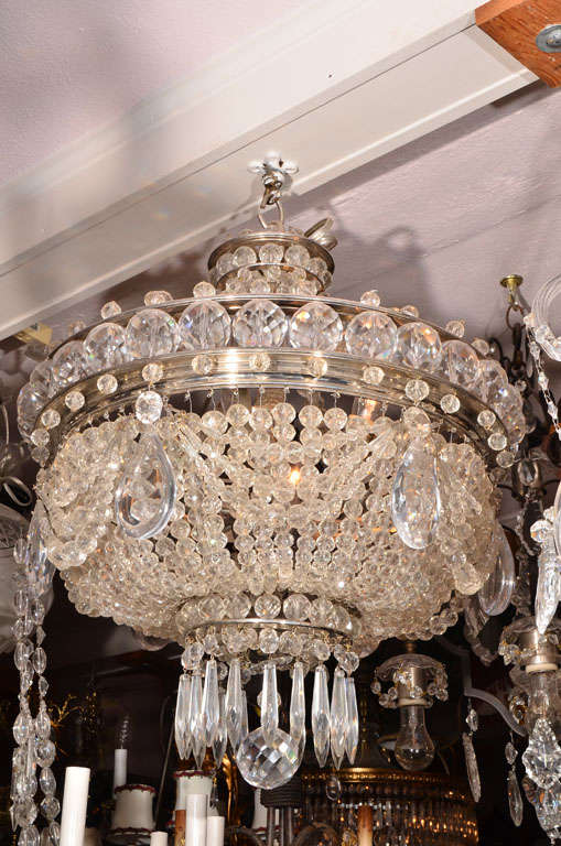 Beautiful crystal basket chandelier, from a lovely home in Paris.  Chandelier is composed of strings of graduating faceted  beads encircled with very large faceted balls at the top and encircled with draped graduating strands of beads interrupted