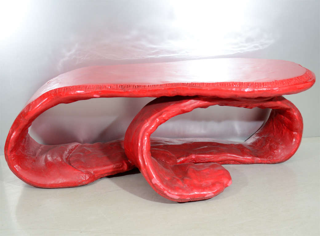 An organic form table in vibrant scarlet. Numbered 3/9 signed and dated.