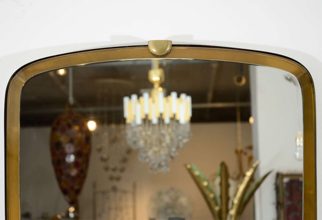 Beautiful beveled mirror with brass accents.