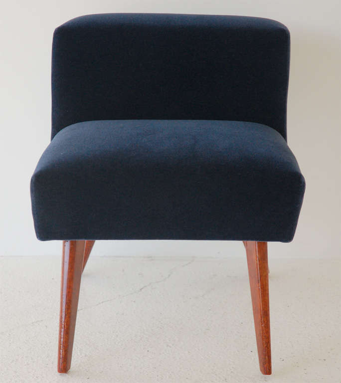 A chic custom Elbow chair by William Haines, featuring a painted finish and new navy blue mohair upholstery.