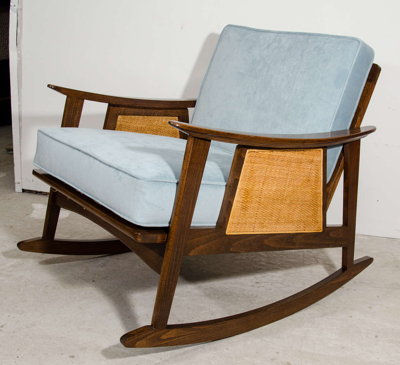 Pair of Mid Century Danish style rocking chair. Newly reupholstered in blue velvet fabric. New webbing support straps below and new finishing. Retro lounge chair. Kick back with a book, Kindle, or baby in the nursery.