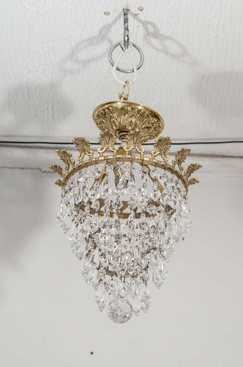 A beautiful flush mounted round ceiling light.with finely crafted bronze leaves and crystal prism.