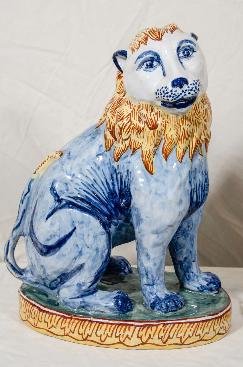 Folk Art A Pair of Antique Faience Lions Painted in Polychrome Blue and Yellow