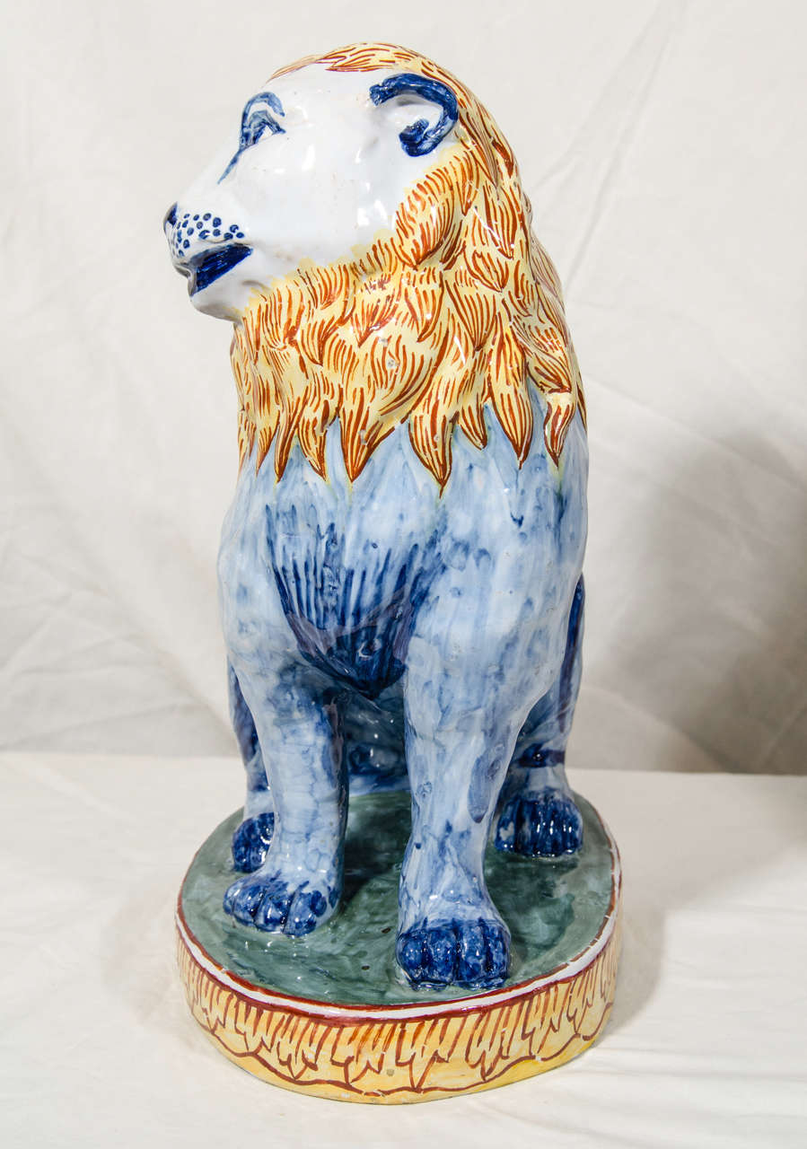 19th Century A Pair of Antique Faience Lions Painted in Polychrome Blue and Yellow