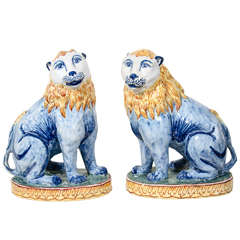 A Pair of Antique Faience Lions Painted in Polychrome Blue and Yellow
