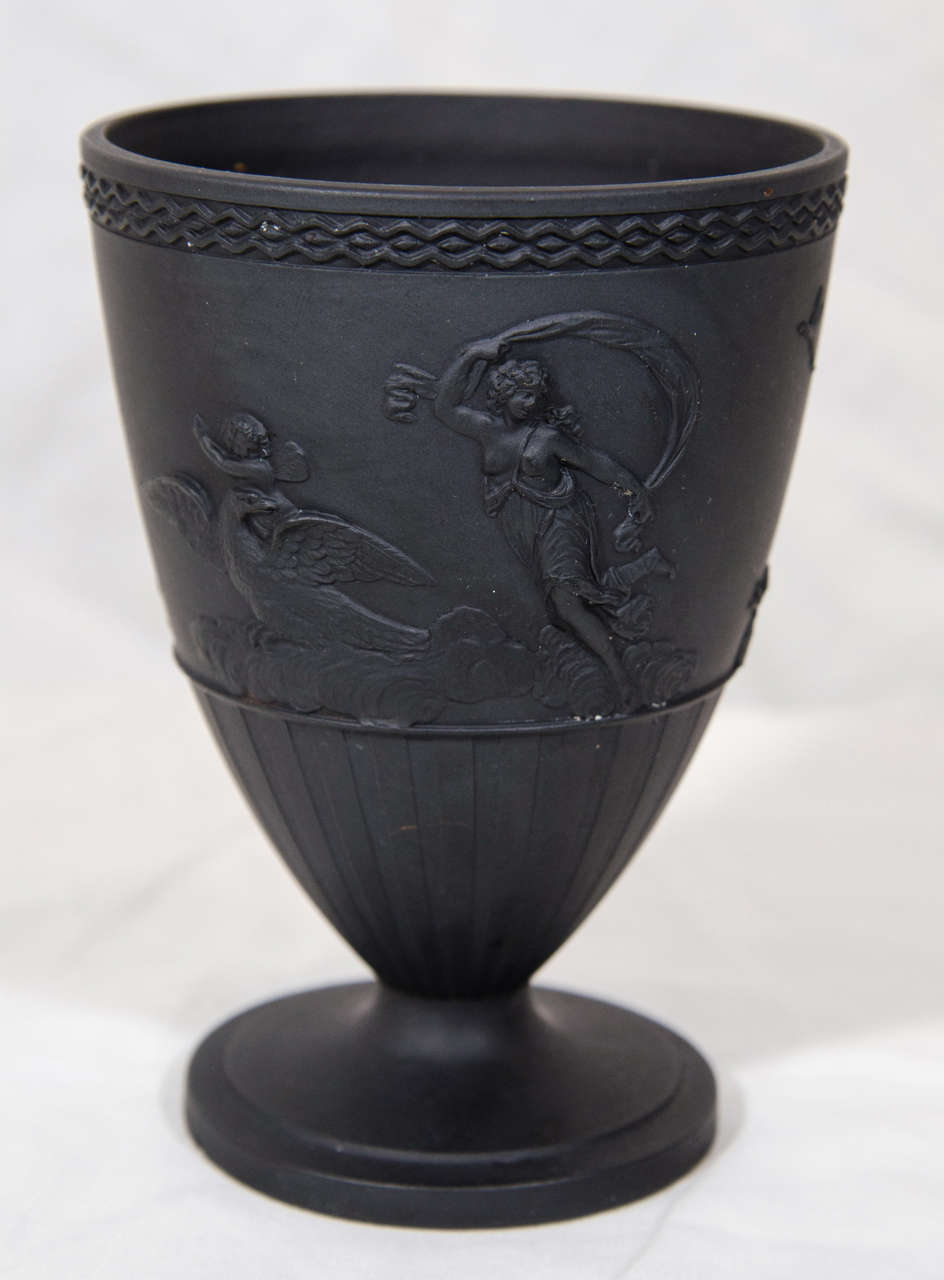 An 18th century Turner black basalt, machine turned cup molded in relief with classical figures at various pursuits with dolphins and an eagle.
The bottom with a late 18th century impressed mark 