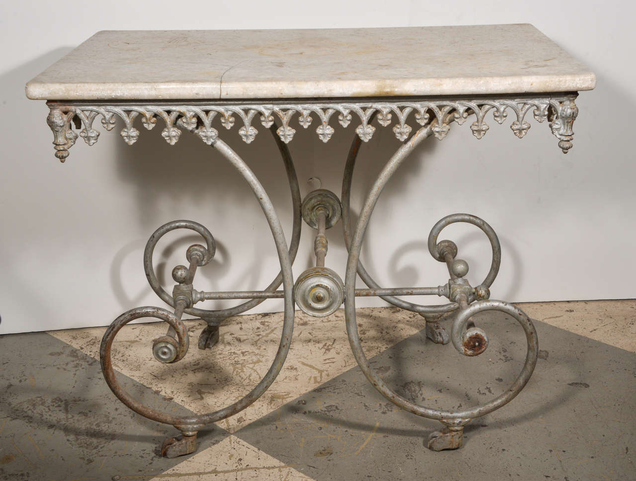 Charming 19th century French butcher table with original marble top, painted iron base on wheels.