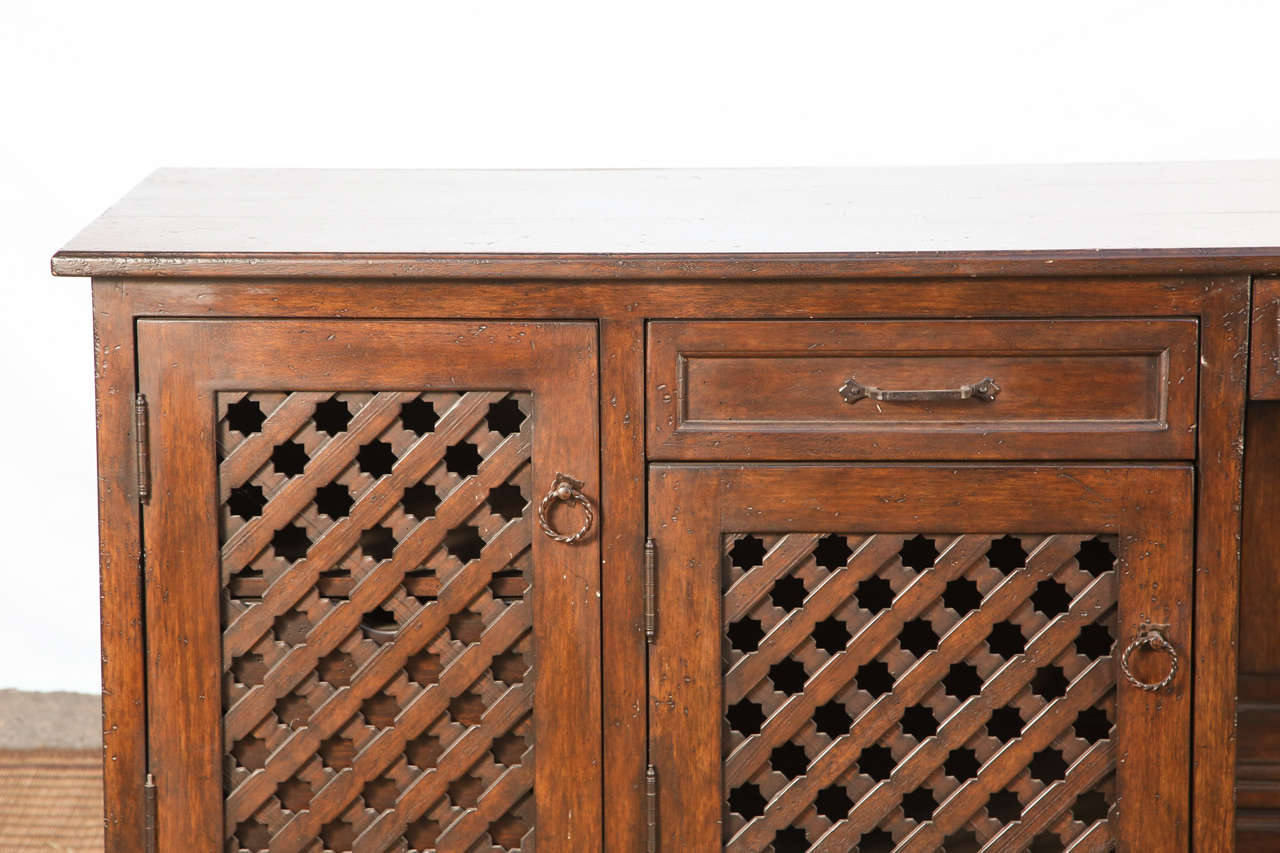 Moroccan handcrafted and custom-made 9 feet dresser, desk, very decorative with nice intricate Moorish stars hand-cut motifs on doors and block feet.
Hispano Moresque style cabinet with drawers and doors.
This most versatile piece will work well as