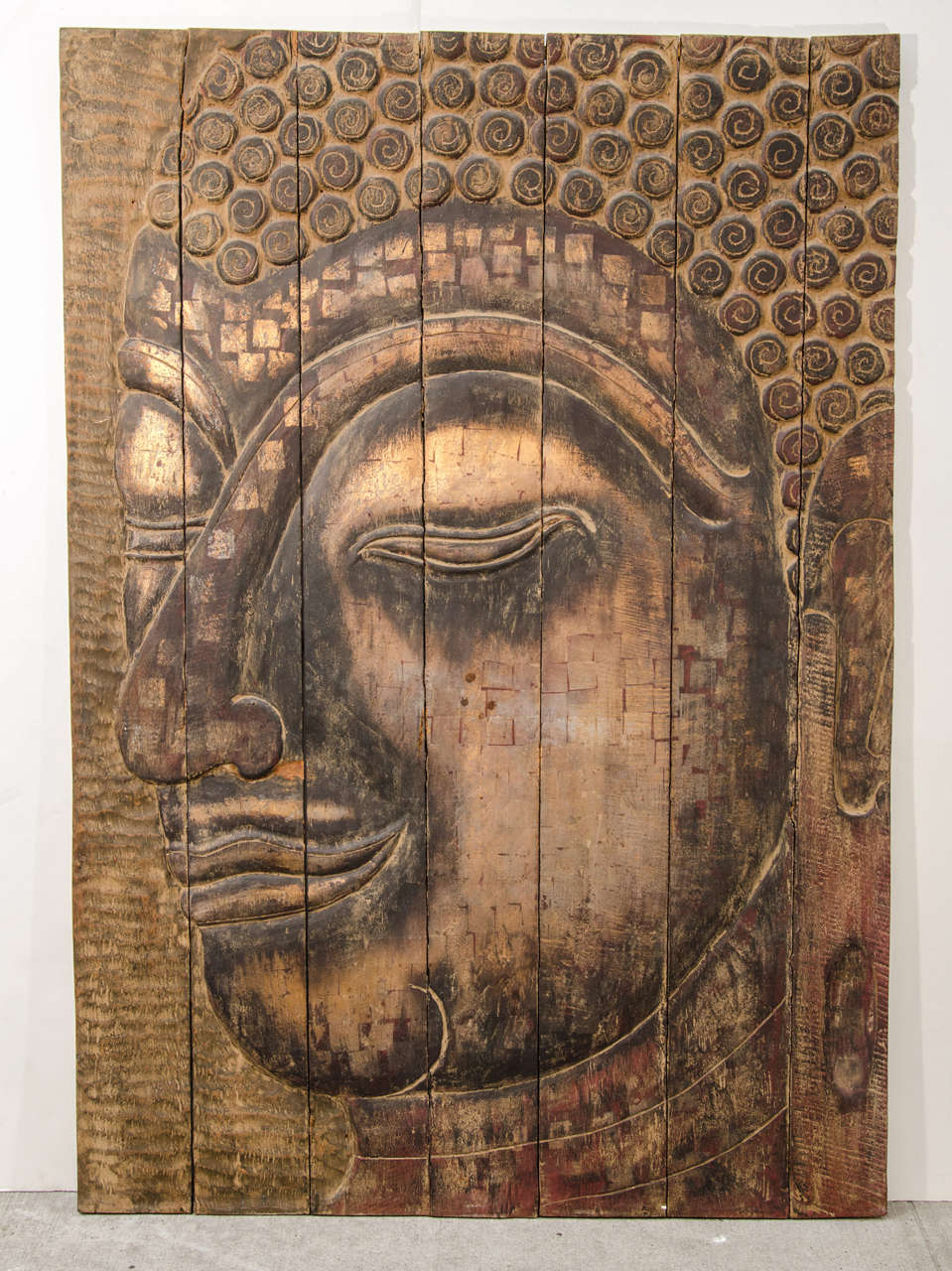 Exceptional contemporary art wall panel of Buddha. The piece is comprised of large wood panel slats vertically aligned to form the face of Buddha. Hand crafted and hand carved from pieces of reclaimed wood.  The panel has a variety of carvings and