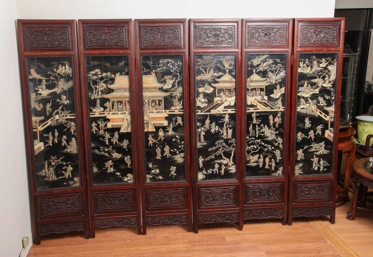 Antique Chinese Carved Rosewood with Polychrome and Lacquer Six-Panel Screen. Lohan figures are present throughout with some riding tigers and elephants as well as others on clouds. The black panels are incased in glass to protect the delicate