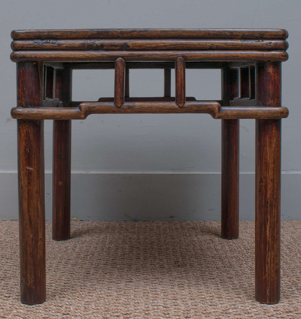 Low, square occasional table, elmwood, mortise and tenon construction, with well-worn patina.