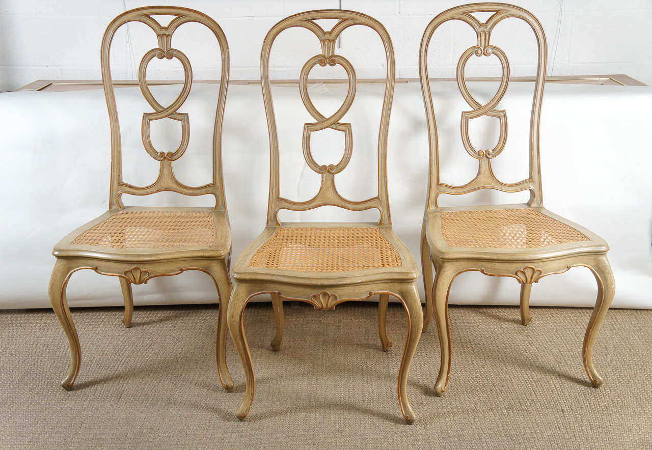 Here is a lovely set of six dining chairs with a painted finish and gold trim detail.