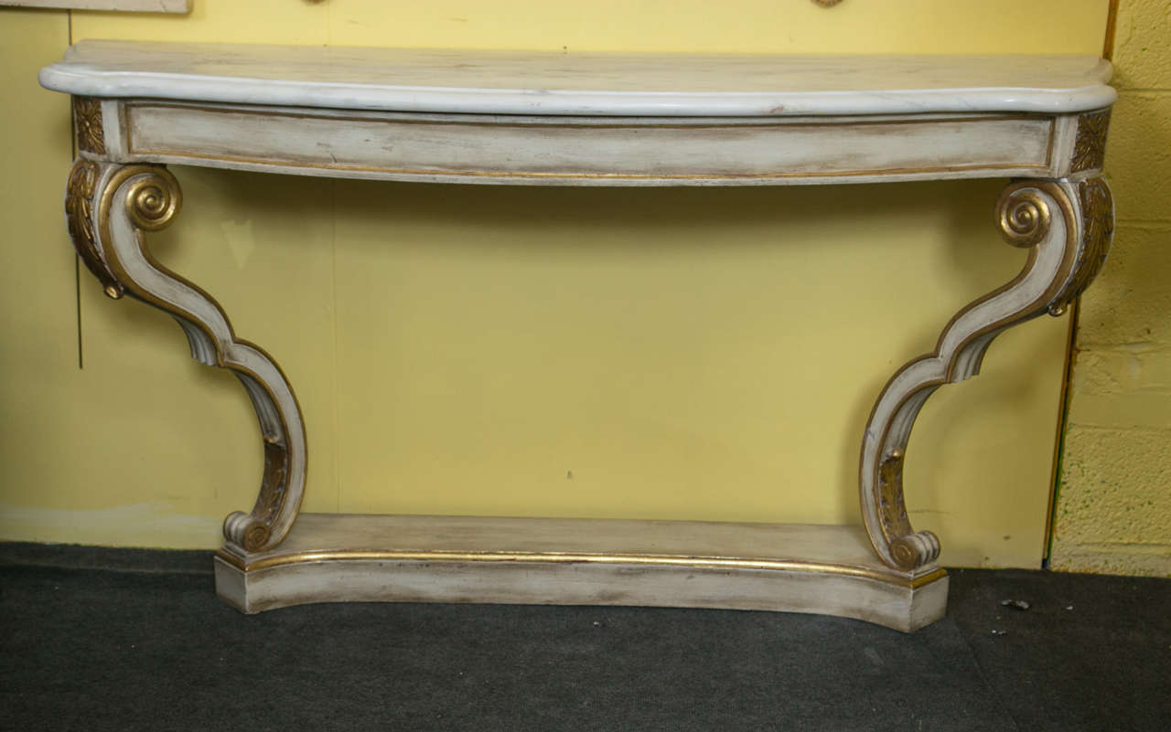 A Pair of Maison Jansen marble-top console tables. A finely detailed pair of Swedish paint decorated consoles with gilt gold hi lights. Each curved leg on a bracket bottom base supports a demilune top under a thick white marble. Each stamped Jansen.