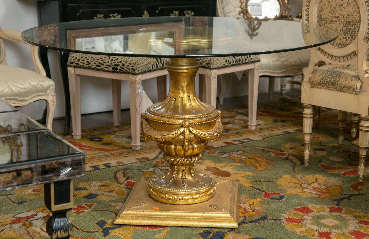 A pair of Louis XVI style glass top center tables. A fine pair of urn based center tables in gilt gold wood. The square (19