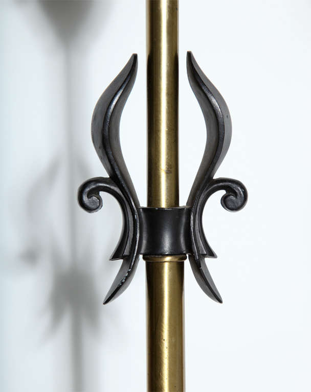 Pair of Brass & Black fleur-de-lis, Black handled Table Lamps by Rembrandt Lamp Company, 1950's.  Featuring a Black enameled metal smooth sculpted fleur-de-lis design and lower grip, cylindrical Brass stem, Brass socket cover and round Brass base