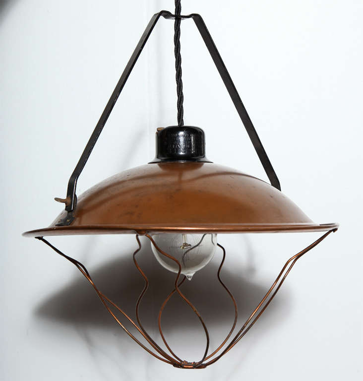 Adjustable All Copper Hanging Pendant, Circa 1920's.  Featuring a solid Copper Shade, Copper bulb protector and standard ceramic socket. Swag. 