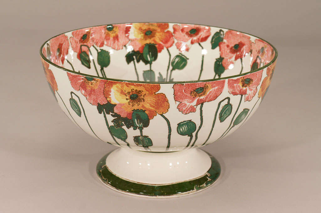 Royal Doulton's rare and sought after pattern in the Arts and Crafts style is the "Poppy" pattern with all over transfer and hand colored decoration. This example is in the rose and yellow color way with green pods encircling the bowl on