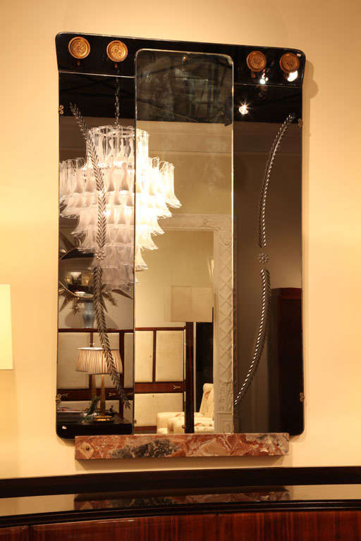 An Italian mirror - hall tree combination attributed to Fontana Arte. Features a full length mirror, flanked by smoke gray mirror, flat brass hooks with a floral design and a red marble base.