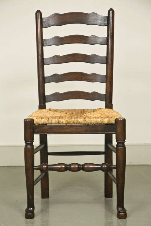 Set of Eight English Oak Wavy Ladder Back Chairs with Rush Seats For