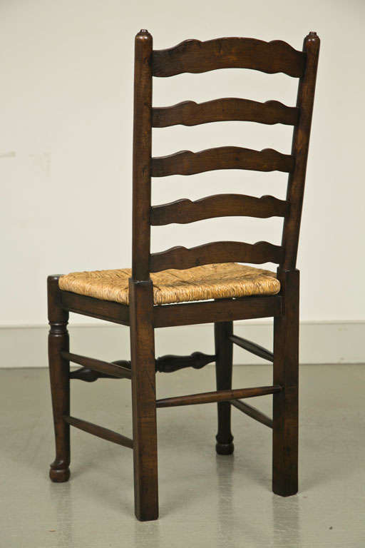 Set of Eight English Oak Wavy Ladder Back Chairs with Rush Seats For