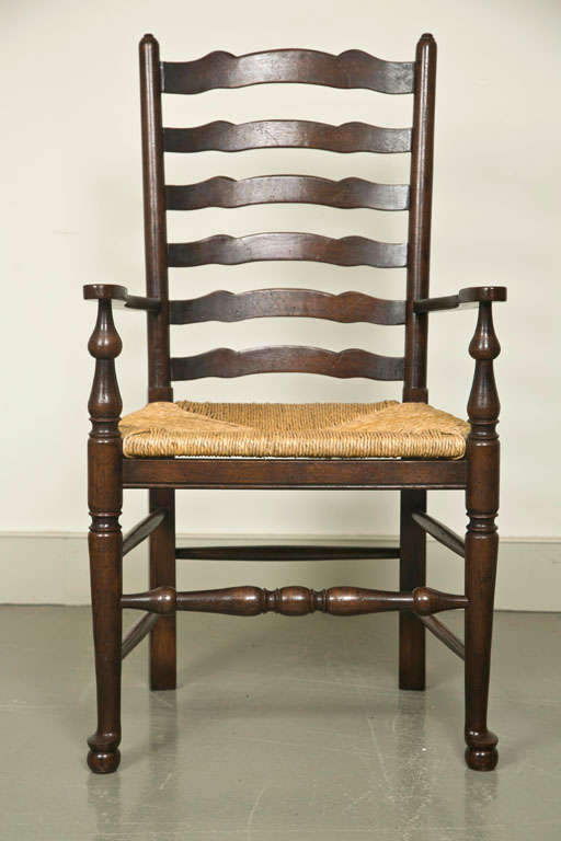 Set of Eight English Oak Wavy Ladder Back Chairs with Rush Seats For