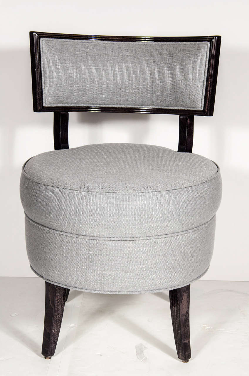 This ultra Chic Mid-Century Modernist Klismos Style Vanity Stool/Chair features a curved  upholstered back and fully upholstered seat in platinum linen and the frame is ebonized walnut. Also, an accompanying pouf/ottoman also available and priced