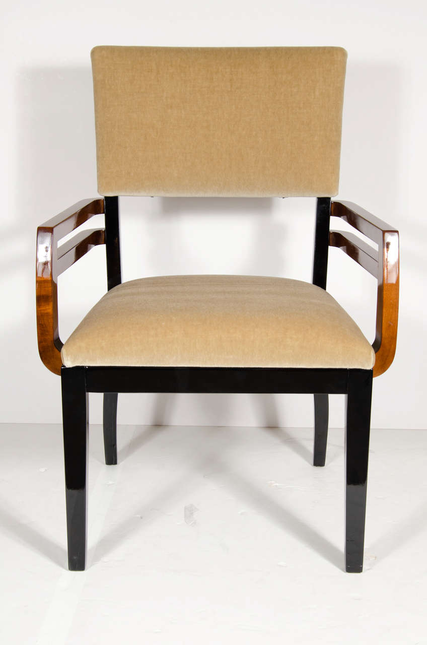 This streamline design chair features arms of burled walnut with black lacquer frame.Newly upholstered in a camel mohair upholstery.This chair represents the best of Machine age influence on Art Deco in America  by one of the best of the Art Deco
