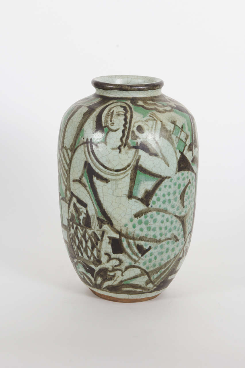 Baluster form, hand thrown and hand painted in various tones of light and dark green with cubist figures and stylized geometric imagery drawn in light and dark shades of brown on an earthenware body depicting two female figures with zig-zag hair and